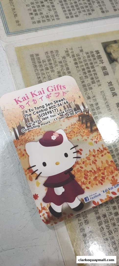 A business card for Kai Kai Gifts featuring a Hello Kitty character in a fall-themed setting.
