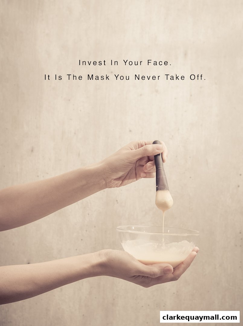 Hands holding a brush with cream, preparing for a facial treatment.