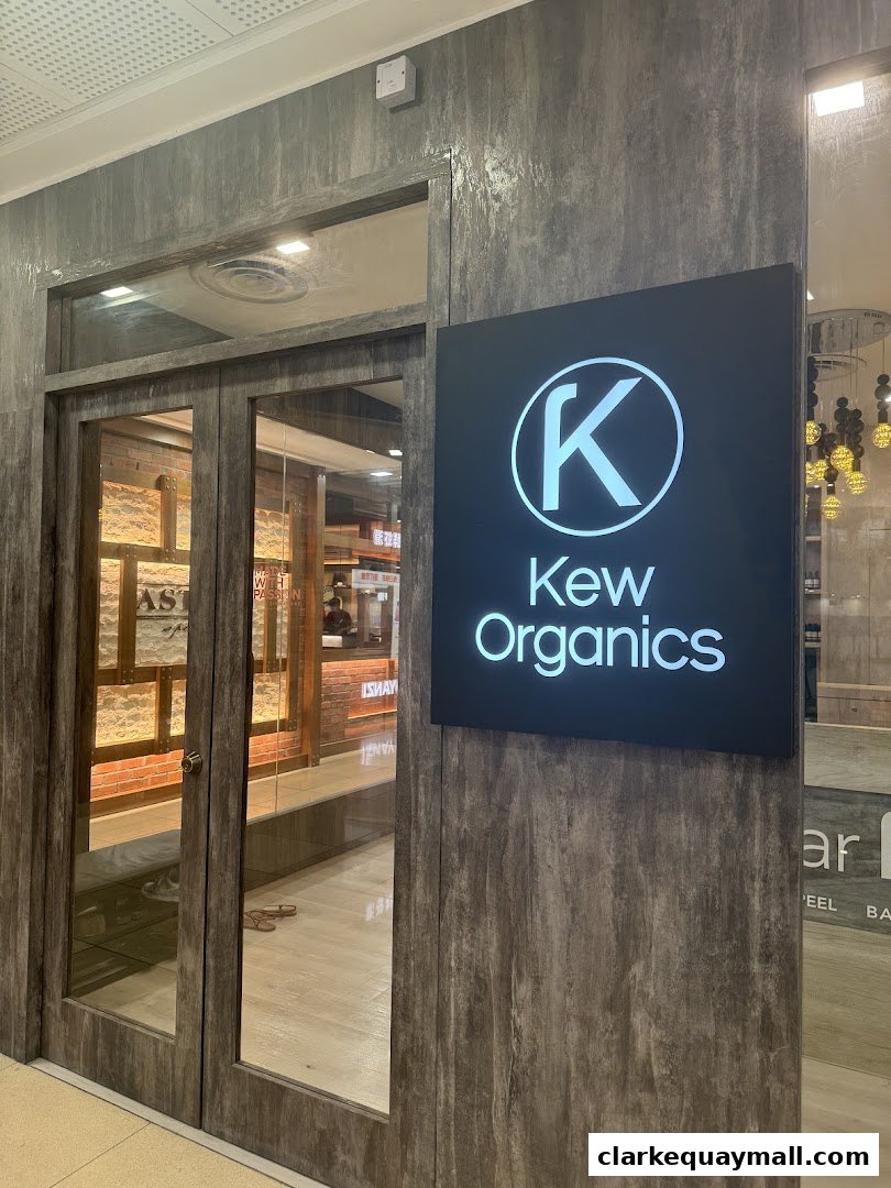 The entrance to Kew Organics Facial Bar, a modern skincare clinic with a prominent illuminated sign.