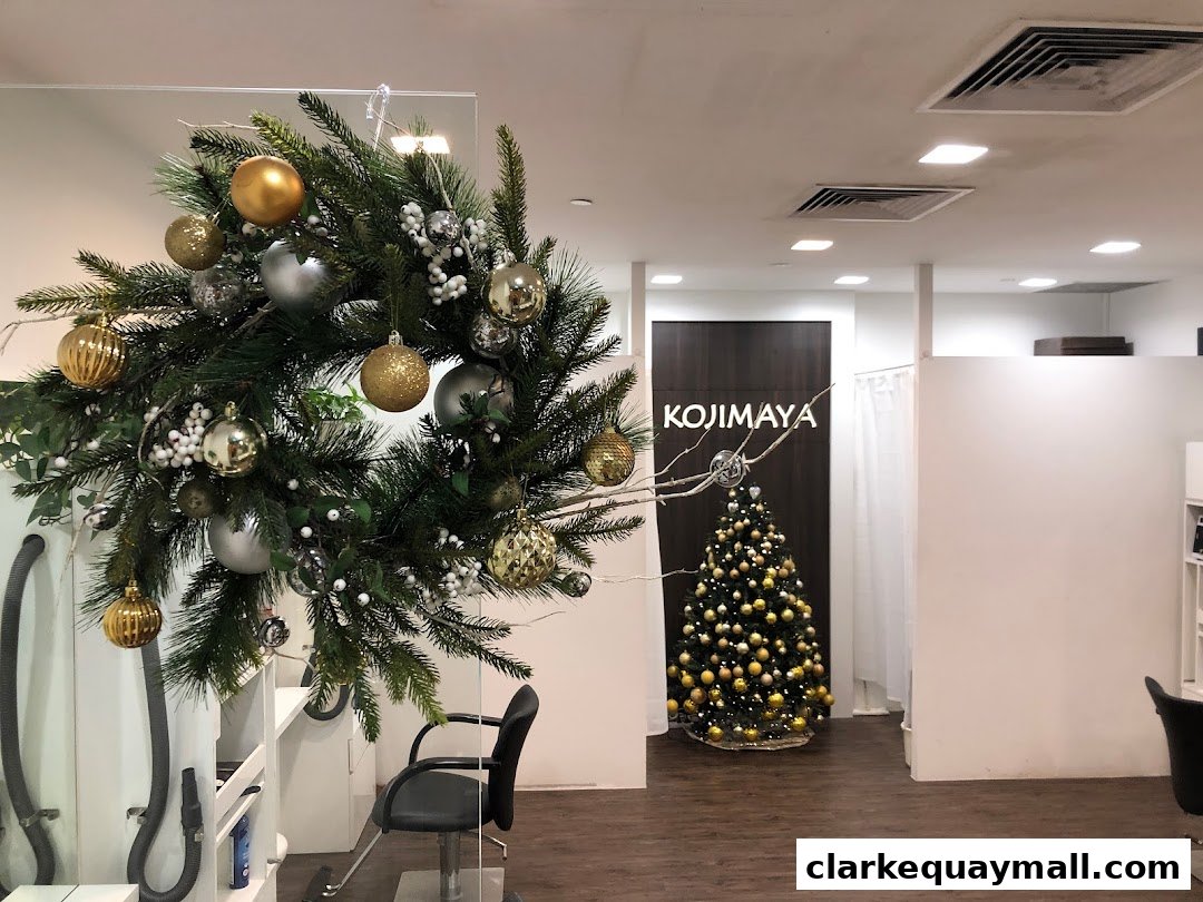 Interior of KOJIMAYA shop decorated for Christmas with a wreath and tree.