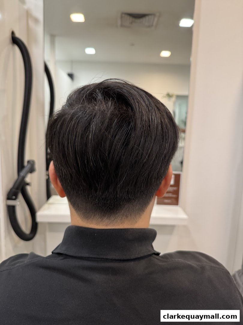 Back view of a person with a fresh haircut, showcasing a clean fade and neat styling.