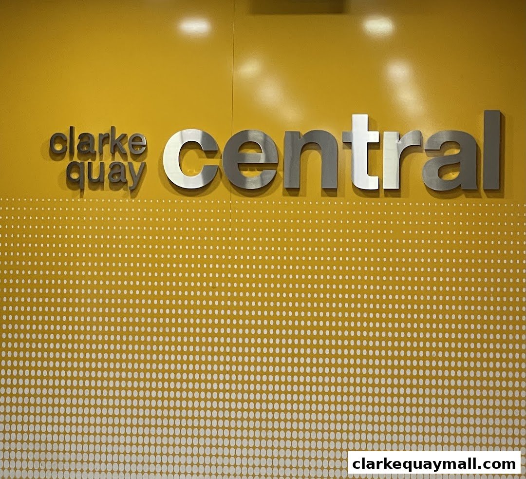 The shop name 'KOJIMAYA' is not visible in this image. The image shows the words 'clarke quay central' in metallic lettering on a yellow background.