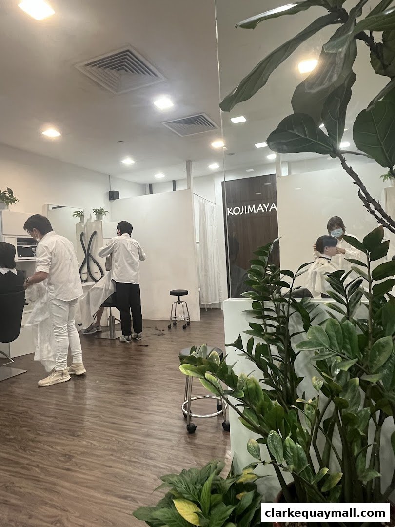 Interior view of a modern hair salon with stylists attending to clients.