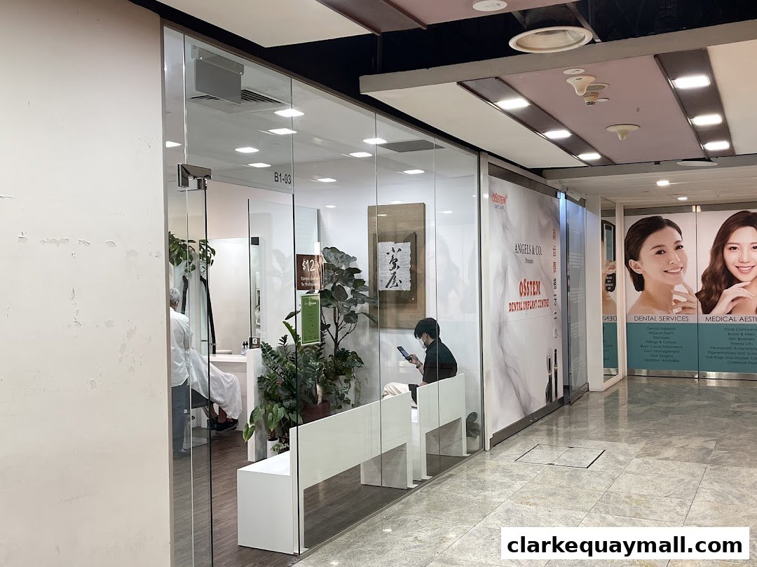 A modern clinic with glass walls, showing a waiting area and a treatment room.