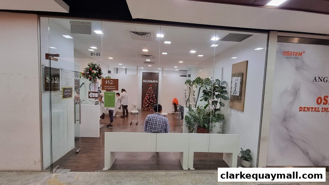 View of KOJIMAYA hair salon interior with staff and customers, featuring a Christmas tree.