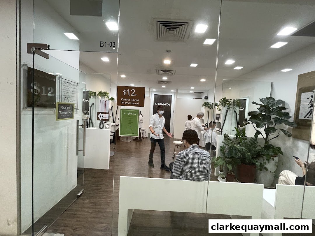 View of a modern hair salon interior with stylists and customers, showcasing a clean and professional atmosphere.