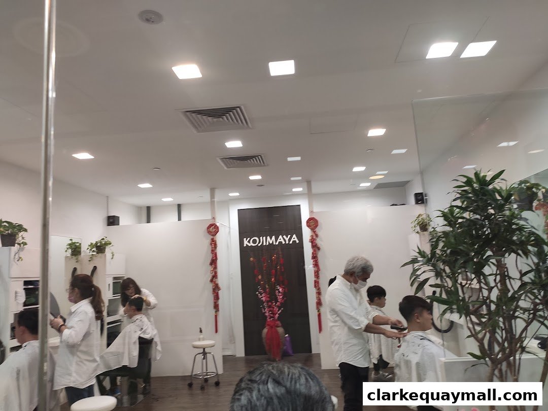 Hairdressers are cutting hair for customers inside a modern salon.