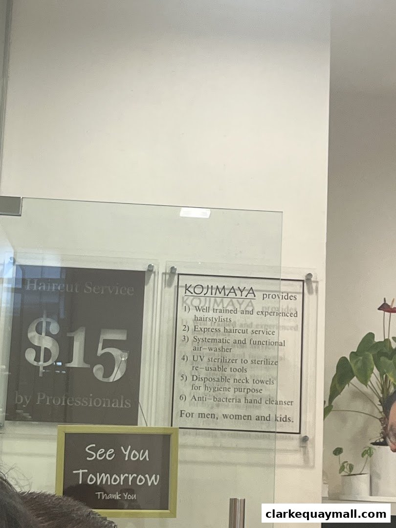 A sign advertises a $15 haircut service by professionals at KOJIMAYA.