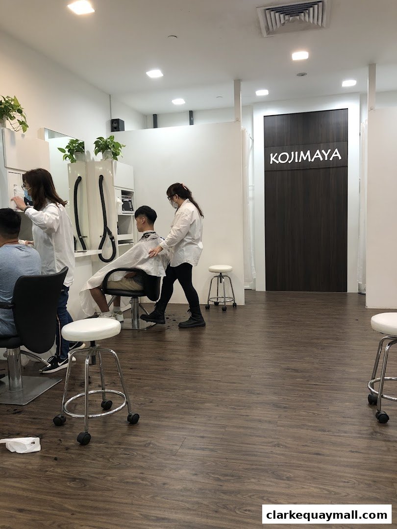 Hairdressers are styling clients' hair in a modern salon with the shop name visible.