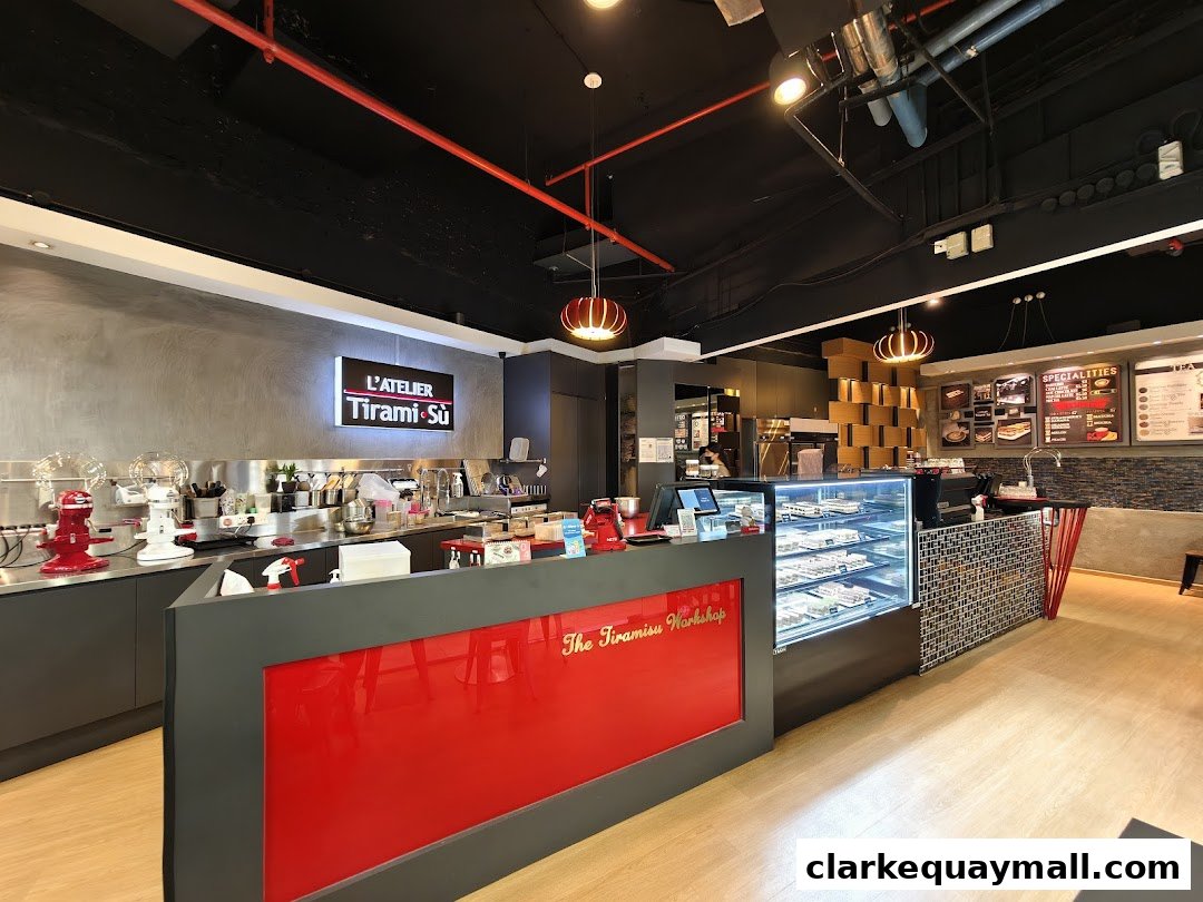 Interior view of L'Atelier Tiramisu shop with display cases and counter.