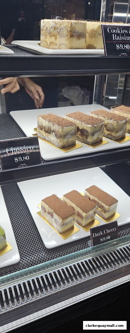 A display case filled with various tiramisu desserts and other pastries.