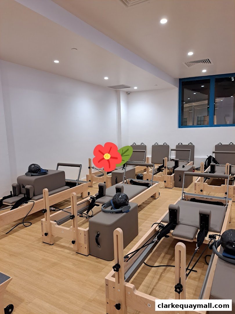 Interior view of a fitness studio with multiple Pilates reformers arranged neatly.