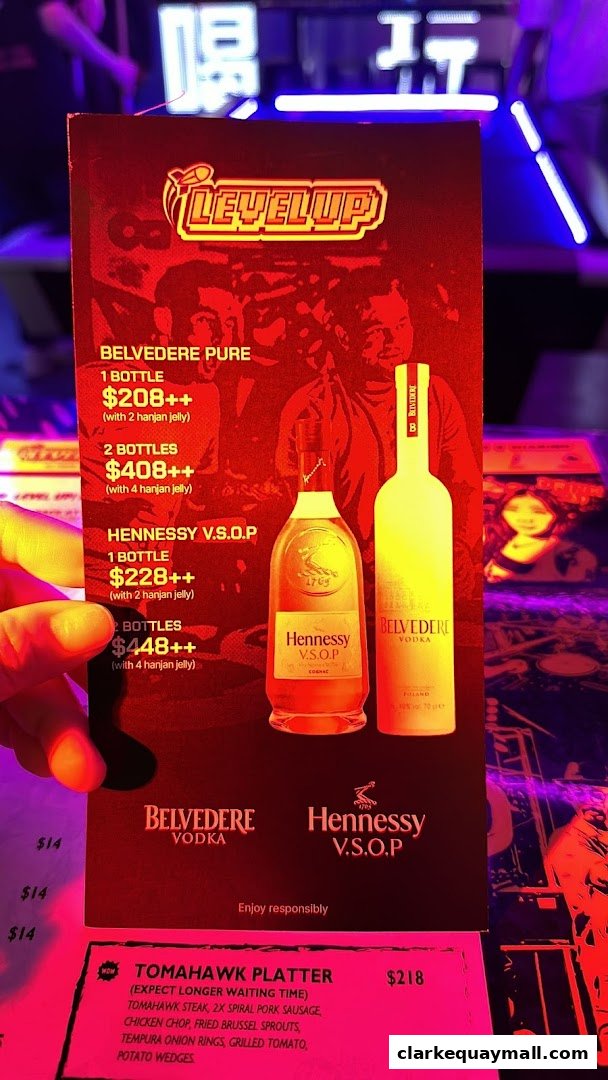 A menu featuring Belvedere Vodka and Hennessy V.S.O.P bottles, and a Tomahawk Platter.