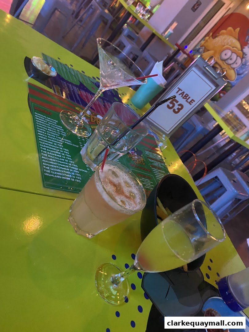 A table at a bar with drinks, menus, and a table number.