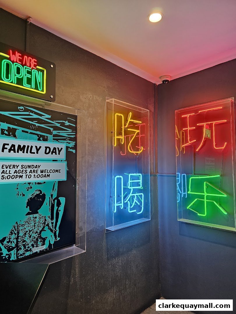 Neon signs in Chinese characters and English reading 'WE ARE OPEN' and 'FAMILY DAY'.