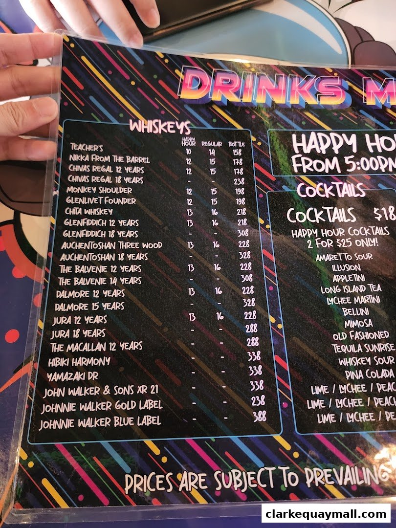 A menu featuring a wide selection of whiskies and cocktails with prices.