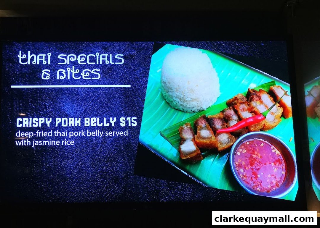 A digital menu displays Thai specials, featuring crispy pork belly with jasmine rice.