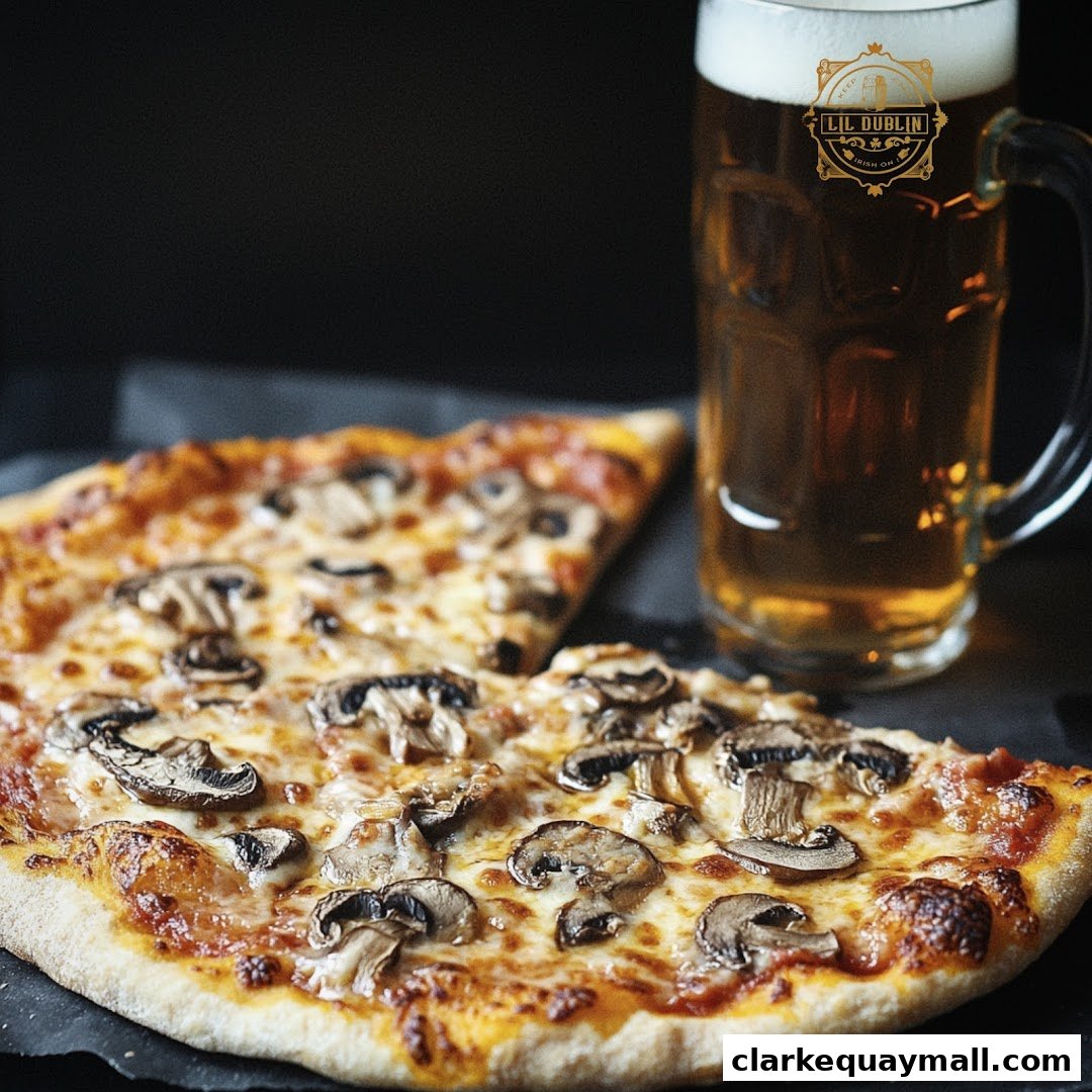A close-up shot of a mushroom pizza with a glass of beer.
