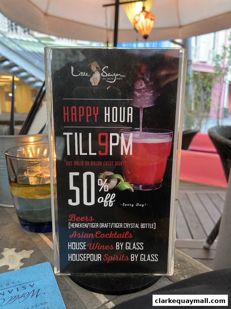 A happy hour sign for Little Saigon offering 50% off drinks until 9 PM.