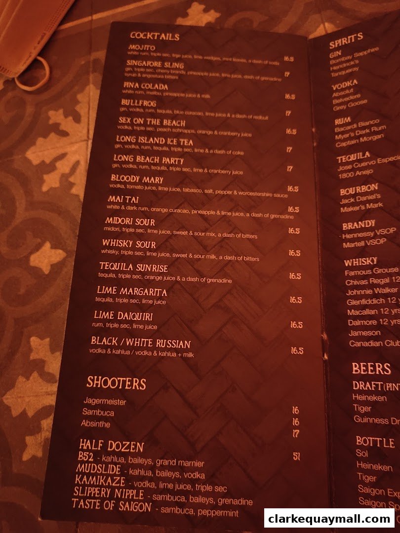 A menu featuring cocktails, spirits, shooters, and beers with prices.