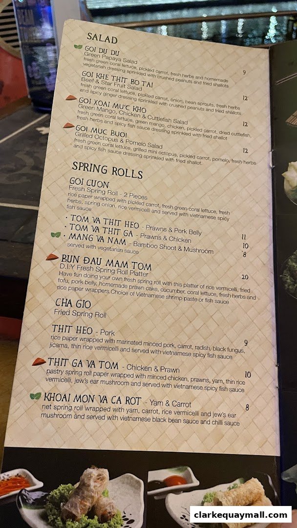 A menu from Little Saigon featuring salads and spring rolls with descriptions and prices.