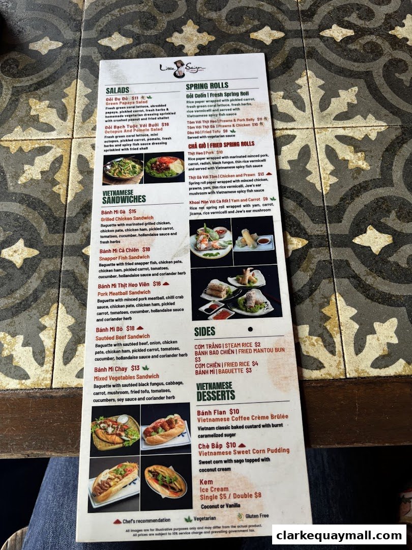 A menu from Little Saigon restaurant featuring Vietnamese dishes like spring rolls, sandwiches, and desserts.