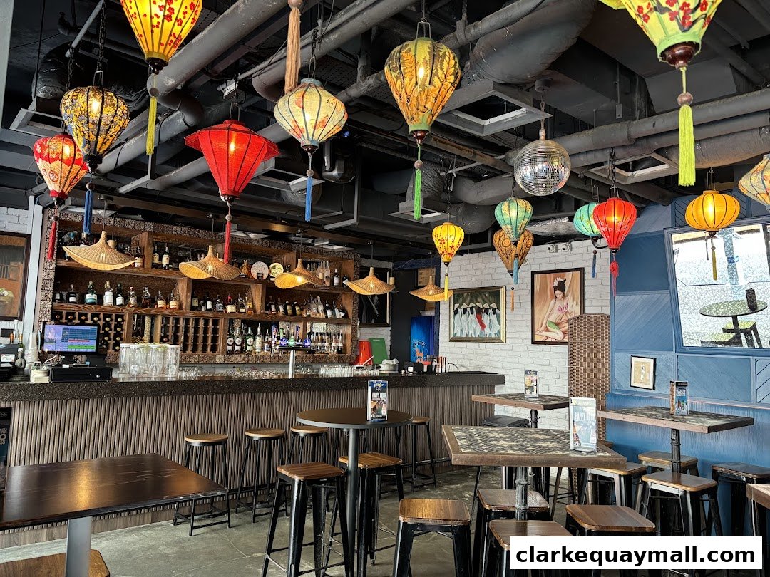 Interior of a bar with colorful lanterns, a disco ball, and a well-stocked bar.