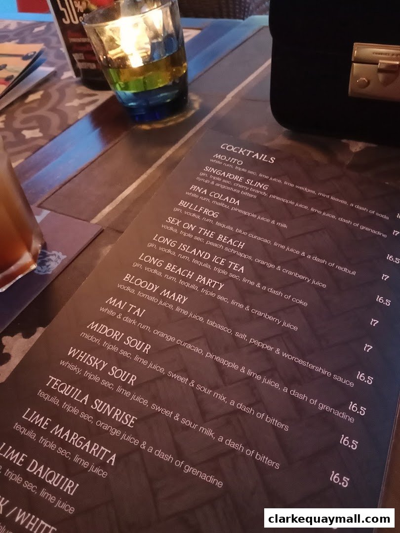 A close-up view of a cocktail menu with various drink names and ingredients listed.