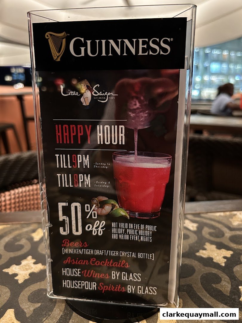 A menu display for Little Saigon featuring happy hour deals and drink selections.