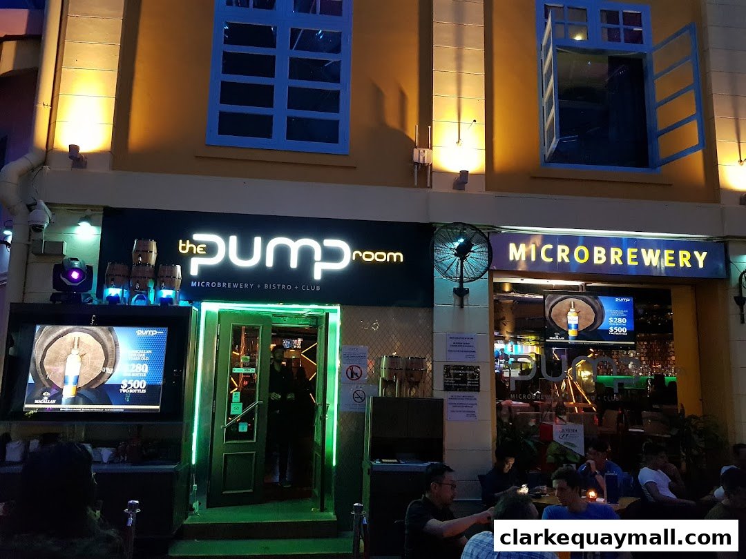 The Pump Room microbrewery, bistro, and club entrance with illuminated signage and outdoor seating.