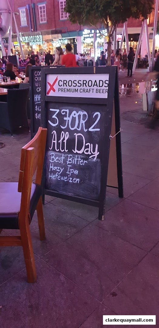 A chalkboard sign outside a bar advertises a 3 for 2 deal on craft beers.