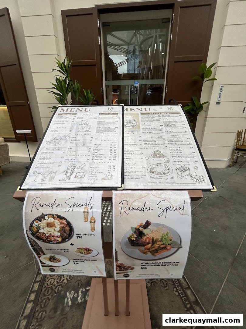 A menu board displaying various dishes and drinks, including Ramadan specials.