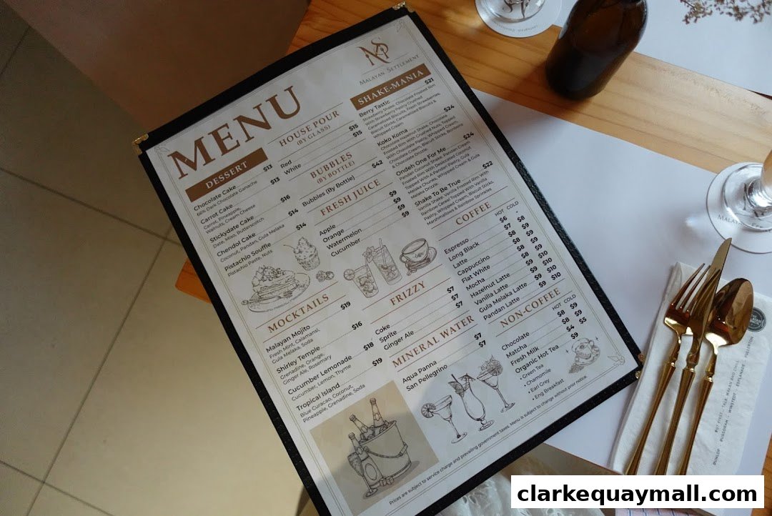 A menu from Malayan Settlement featuring desserts, shakes, mocktails, juices, coffee, and non-coffee drinks.