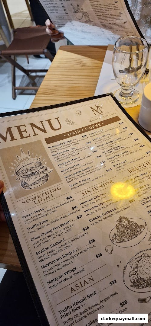 A menu from Malayan Settlement restaurant with various main courses, junior meals, and Asian dishes.
