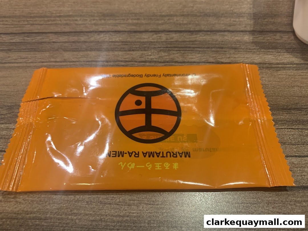 An orange packet with the Marutama Ramen logo and text.