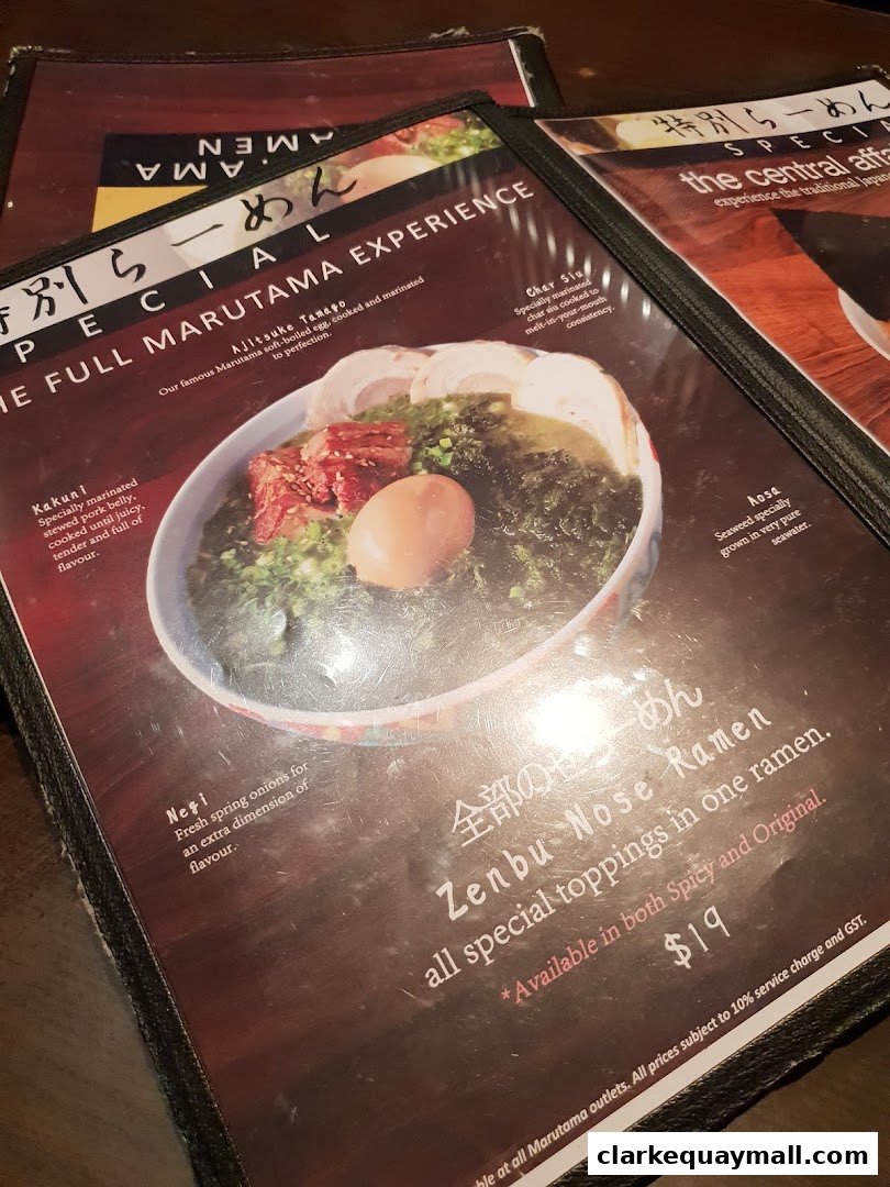 A close-up of a ramen menu featuring a bowl of ramen with various toppings and descriptions.
