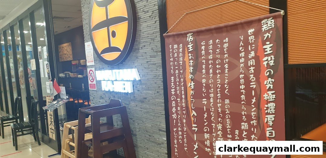 The entrance of Marutama Ramen The Central with its logo and a promotional banner.