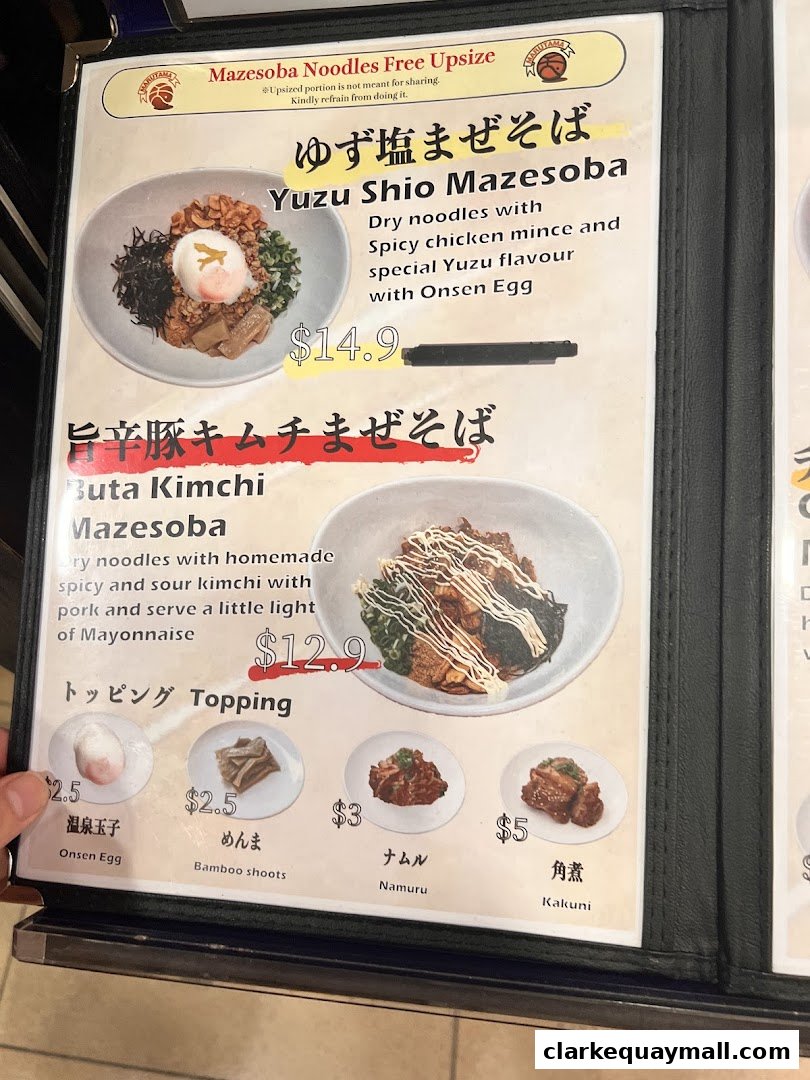 A menu from Marutama Ramen featuring Yuzu Shio Mazesoba and Buta Kimchi Mazesoba with topping options.