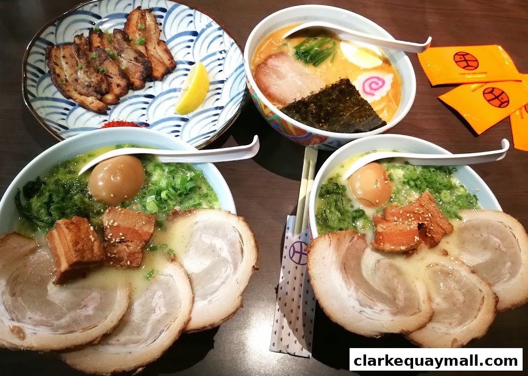 Three bowls of ramen and a plate of chashu pork are arranged on a wooden table.