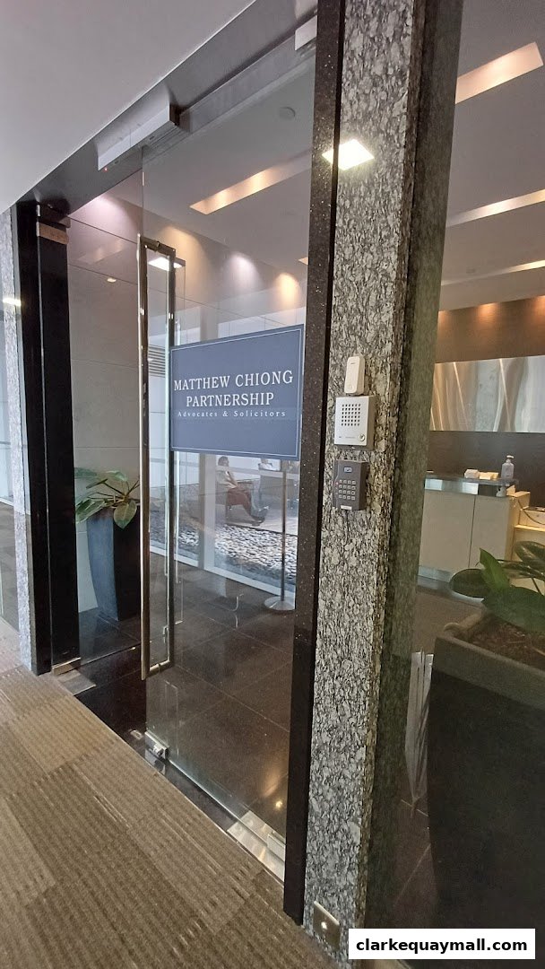 The entrance to Matthew Chiong Partnership, Advocates & Solicitors, featuring glass doors and a stone pillar.