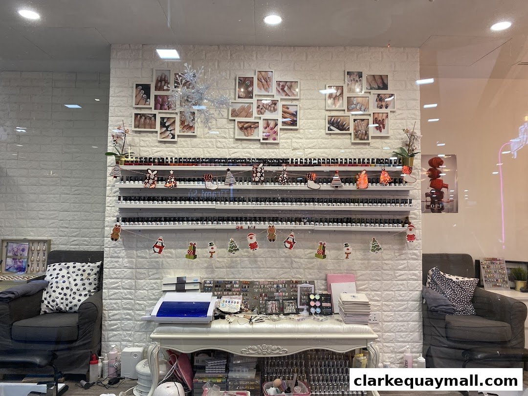 Interior view of a nail salon with shelves of nail polish and decorative holiday items.