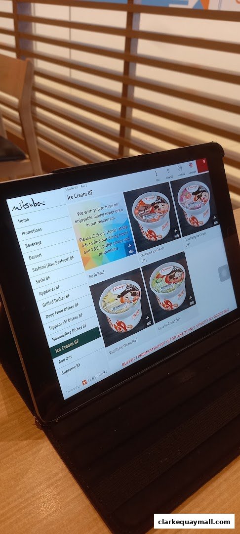 A tablet displays the Mitsuba Japanese Restaurant menu, featuring ice cream options.