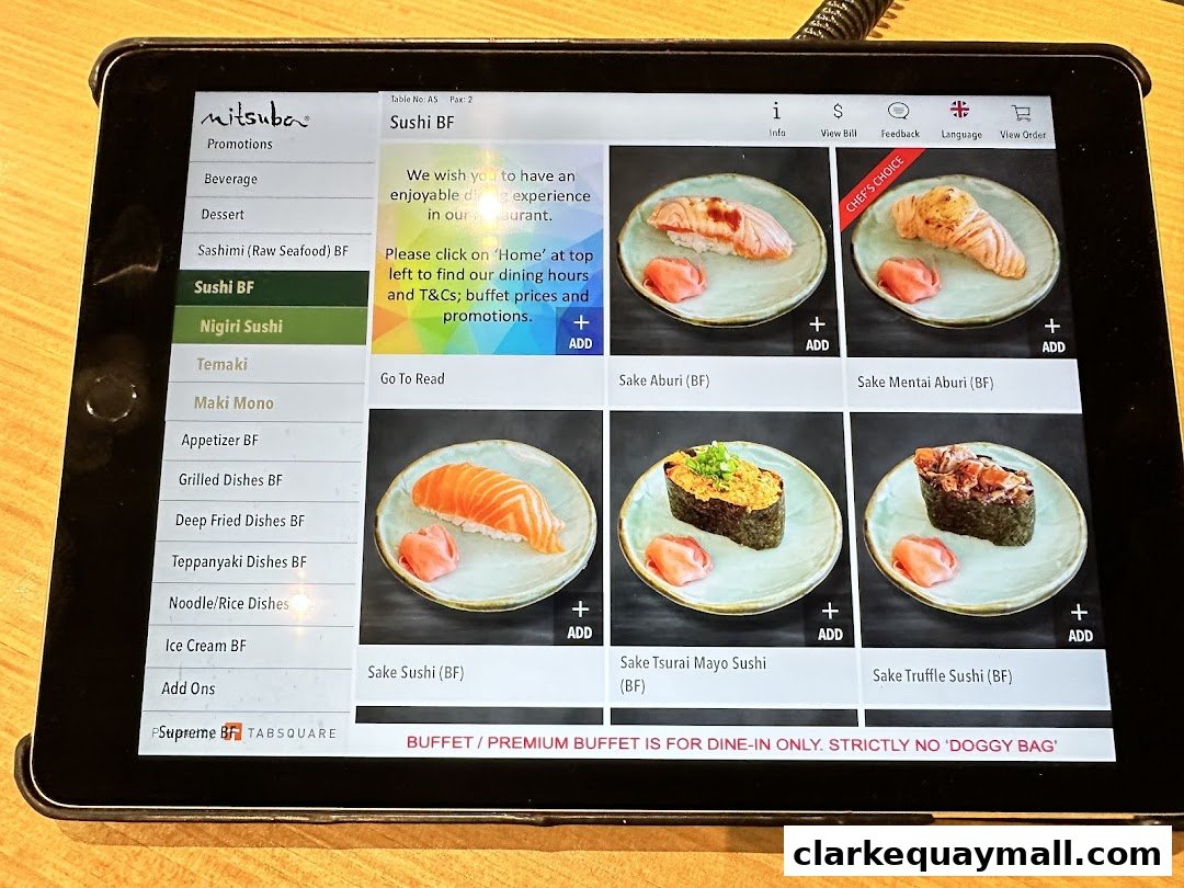 A tablet displaying the Mitsuba Japanese Restaurant menu with various sushi options.