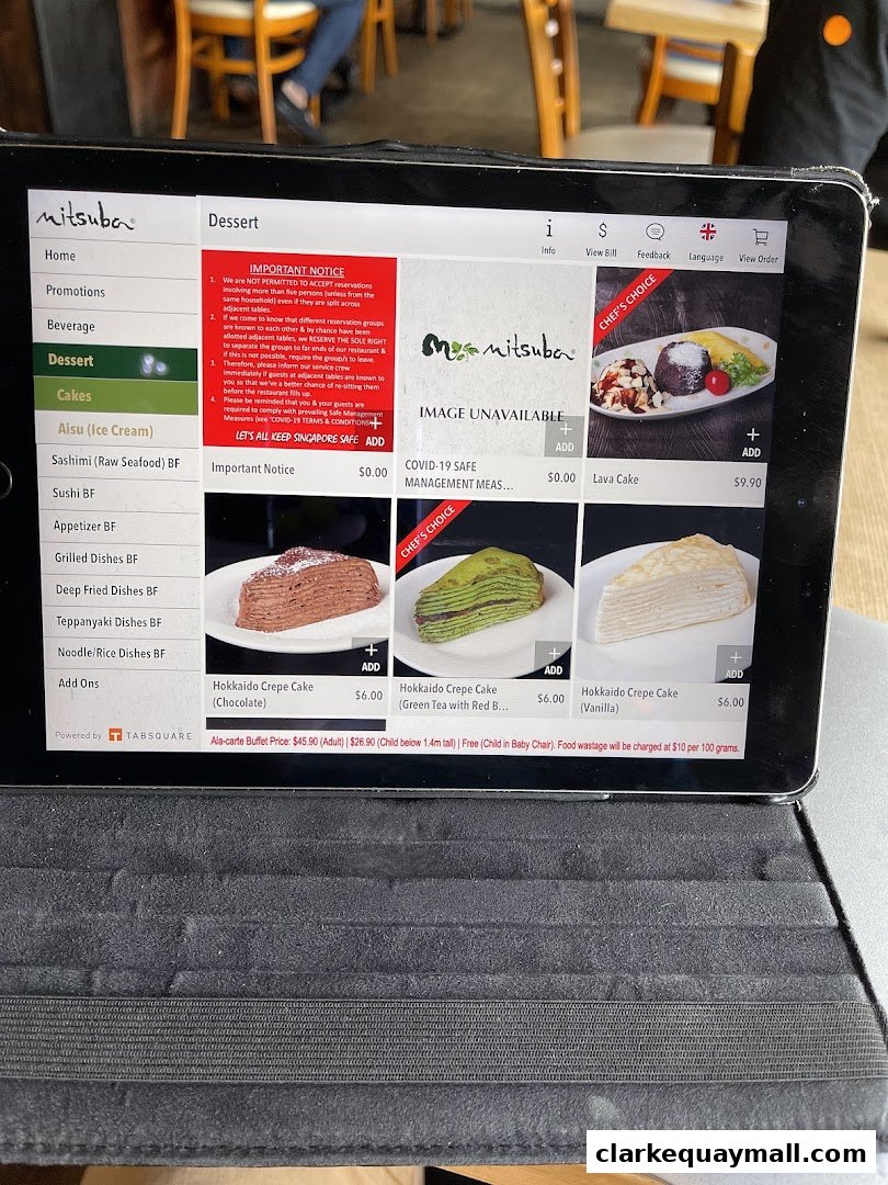 A tablet displays the dessert menu of Mitsuba Japanese Restaurant with various crepe options.
