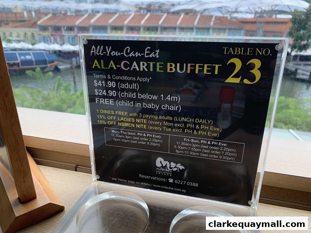 A sign advertising an all-you-can-eat a la carte buffet at Mitsuba Japanese Restaurant.
