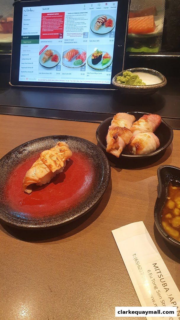 A close-up of delicious sushi and appetizers served at Mitsuba Japanese Restaurant.