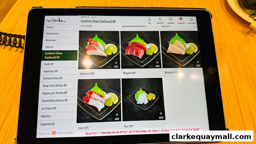 A tablet displays the Mitsuba Japanese Restaurant's sashimi menu with images and options.