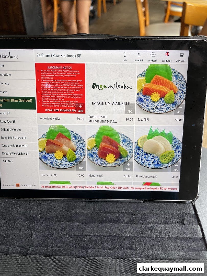 A tablet displaying the Mitsuba Japanese Restaurant menu with sashimi options.