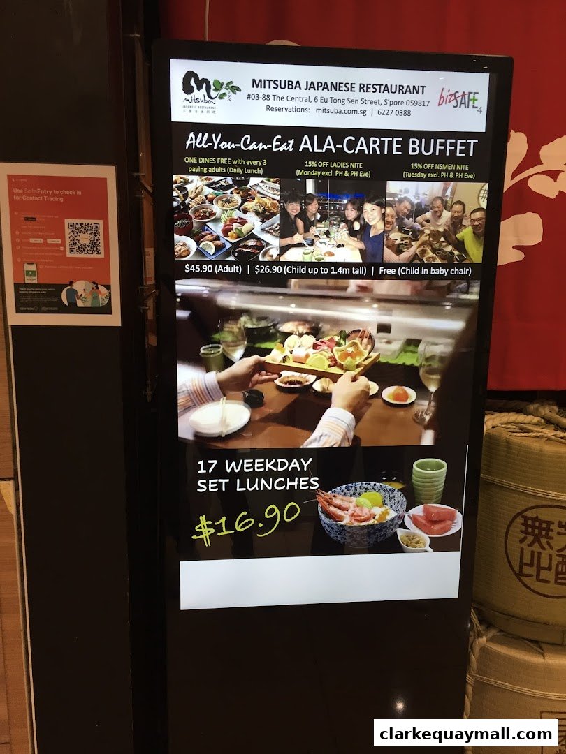 A digital display board advertising Mitsuba Japanese Restaurant's all-you-can-eat buffet and weekday set lunches.