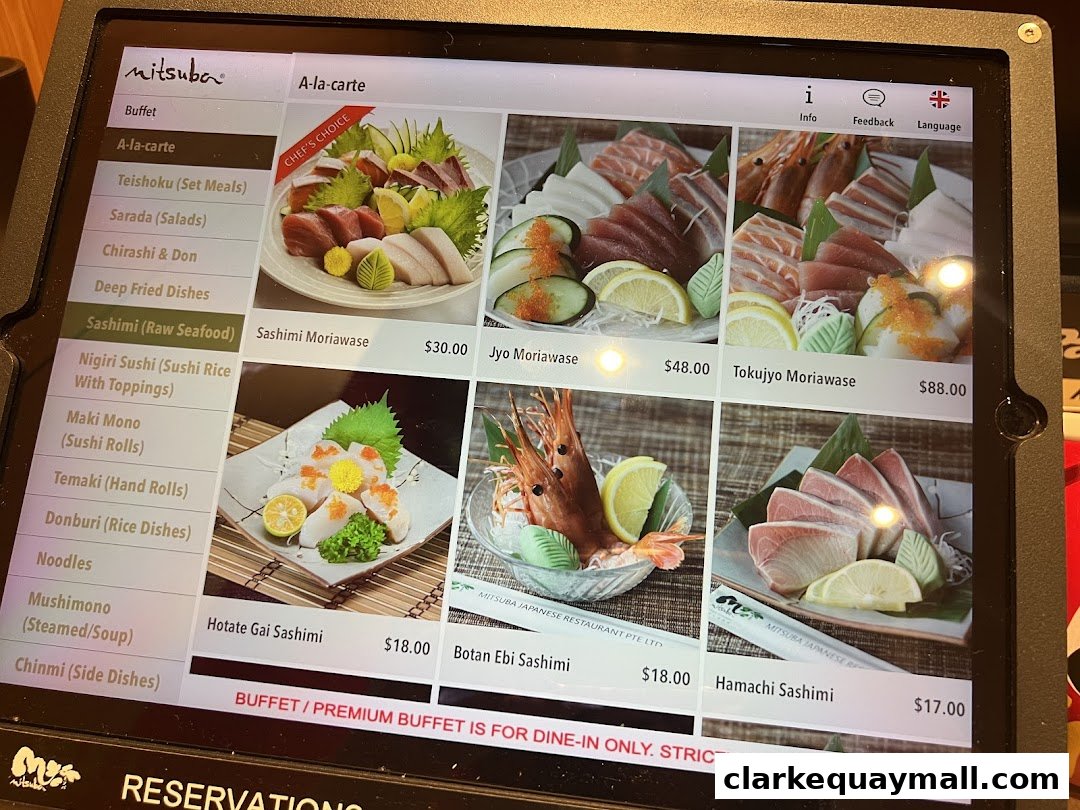 A digital menu displaying various sashimi dishes with prices at Mitsuba Japanese Restaurant.